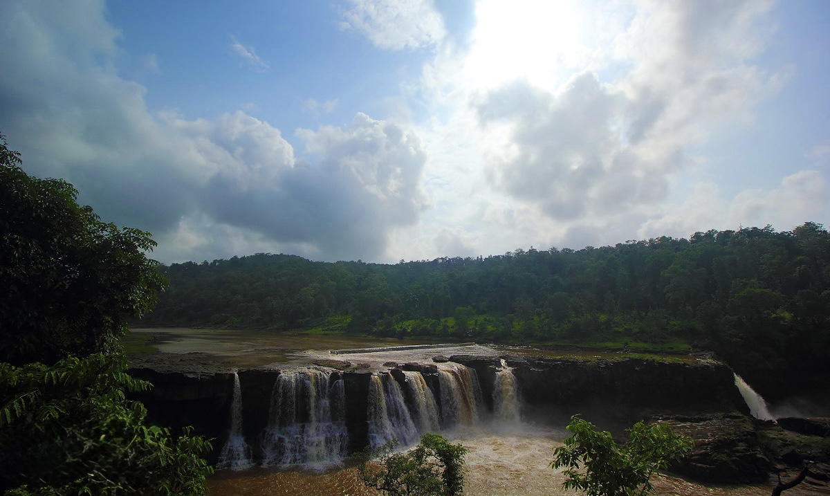 A wide green valley under monsoon clouds in the Dangs