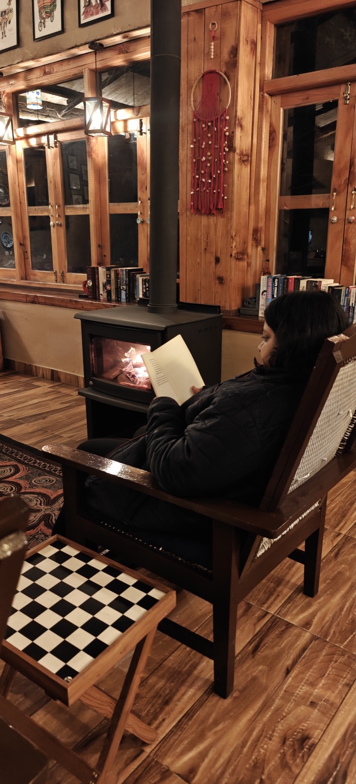 The common room of the heritage stay — wooden, warm, a chessboard floor